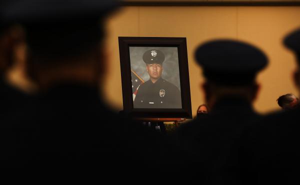 Colleagues, family and friends attend the August funeral of Los Angeles police Officer Valentin Martinez, the agency's first sworn officer to die of complications from COVID-19. Colleagues, family and friends attend the August funeral of Los Angeles police Officer Valentin Martinez, the agency's first sworn officer to die of complications from COVID-19.