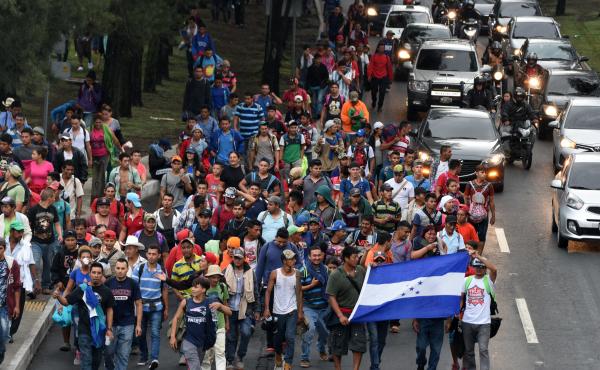 Honduran migrants walk toward Tecún Umán, a Guatemalan town along the Mexican border, as they leave Guatemala City on Thursday. Honduran migrants walk toward Tecún Umán, a Guatemalan town along the Mexican border, as they leave Guatemala City on Thursday.