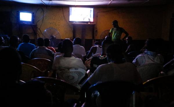 At the Arsenal video club, men sit shoulder to shoulder. But some still say it's too dangerous to go in because of Ebola. At the Arsenal video club, men sit shoulder to shoulder. But some still say it's too dangerous to go in because of Ebola.