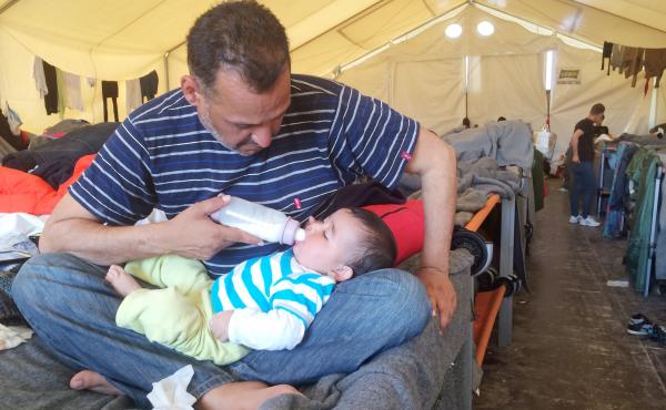 Moyaad Saad, a 43-year-old former civil servant from Baghdad, feeds his 6-month-old daughter Zahara on their cot in a giant tent at a makeshift migrant camp near the border between Greece and Macedonia. Thousands of asylum seekers are now stuck here after Moyaad Saad, a 43-year-old former civil servant from Baghdad, feeds his 6-month-old daughter Zahara on their cot in a giant tent at a makeshift migrant camp near the border between Greece and Macedonia. Thousands of asylum seekers are now stuck here after