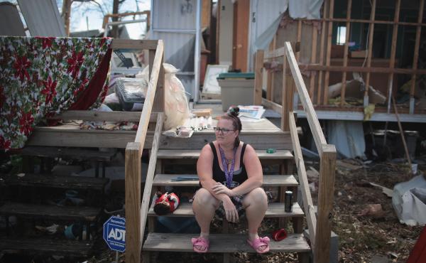 Kimbrely Brock sits on the steps of a friend's trailer that was destroyed by Hurricane Michael in Panama City, Fla., in October. President Trump holds a political rally in Panama City Wednesday. Kimbrely Brock sits on the steps of a friend's trailer that was destroyed by Hurricane Michael in Panama City, Fla., in October. President Trump holds a political rally in Panama City Wednesday.
