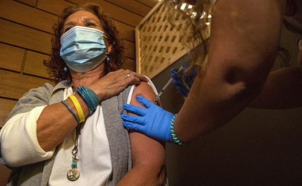 Edna Halup, a staff member at a private nursing home, receives a Pfizer COVID-19 vaccine, in Ganei Tikva, Israel, on Dec. 22. Edna Halup, a staff member at a private nursing home, receives a Pfizer COVID-19 vaccine, in Ganei Tikva, Israel, on Dec. 22.