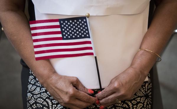 A participant in a 2018 naturalization ceremony holds a U.S. flag in New York City. Research by the Census Bureau suggests the citizenship question is highly likely to scare households with noncitizens from taking part in the constitutionally mandated hea A participant in a 2018 naturalization ceremony holds a U.S. flag in New York City. Research by the Census Bureau suggests the citizenship question is highly likely to scare households with noncitizens from taking part in the constitutionally mandated hea