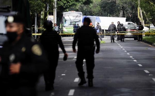 Police officers guard a crime scene following an assassination attempt on Mexico City's chief of police Omar García Harfuch, in Mexico City last month. Police officers guard a crime scene following an assassination attempt on Mexico City's chief of police Omar García Harfuch, in Mexico City last month.