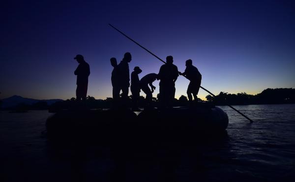 Honduran migrants arrive at dawn Monday in Ciudad Hidalgo, in Mexico's far southwest. They used a makeshift raft to cross the Suchiate River, which forms part of the natural border between Guatemala and Mexico. Honduran migrants arrive at dawn Monday in Ciudad Hidalgo, in Mexico's far southwest. They used a makeshift raft to cross the Suchiate River, which forms part of the natural border between Guatemala and Mexico.