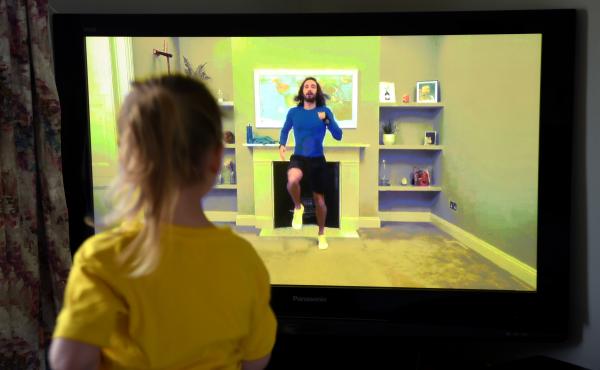 Four-year-old Lois Copley-Jones, the photographer's daughter, takes part in a livestreamed broadcast of "PE With Joe" on March 23, 2020, in Newcastle-under-Lyme, England. The popular fitness series ended Friday. Four-year-old Lois Copley-Jones, the photographer's daughter, takes part in a livestreamed broadcast of "PE With Joe" on March 23, 2020, in Newcastle-under-Lyme, England. The popular fitness series ended Friday.