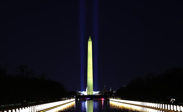 Columns along the sides of the Lincoln Memorial Reflecting Pool pay tribute to victims of COVID-19 at a Jan. 19 memorial. Just over a month later, a Monday evening ceremony will pay tribute to 500,000 Americans lives lost. Columns along the sides of the Lincoln Memorial Reflecting Pool pay tribute to victims of COVID-19 at a Jan. 19 memorial. Just over a month later, a Monday evening ceremony will pay tribute to 500,000 Americans lives lost.