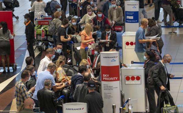 People line up to get on the Air France flight to Paris at OR Tambo's airport in Johannesburg, South Africa, on Nov. 26. The United States, Israel and other European nations have already imposed travel restrictions on South Africa and other nations in the People line up to get on the Air France flight to Paris at OR Tambo's airport in Johannesburg, South Africa, on Nov. 26. The United States, Israel and other European nations have already imposed travel restrictions on South Africa and other nations in the