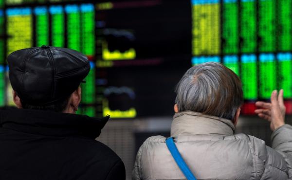 Two investors chat while keeping an eye on stock price movements shown on a screen at a securities company in Shanghai on Friday. Two investors chat while keeping an eye on stock price movements shown on a screen at a securities company in Shanghai on Friday.