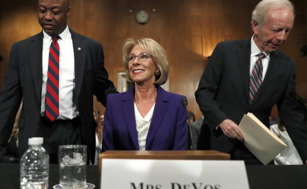 Education Secretary nominee Betsy DeVos arrives with former Sen. Joe Lieberman (right) and Sen. Tim Scott, R-S.C., before testifying on Capitol Hill on Tuesday at her confirmation hearing before the Senate Health, Education, Labor and Pensions Committee. Education Secretary nominee Betsy DeVos arrives with former Sen. Joe Lieberman (right) and Sen. Tim Scott, R-S.C., before testifying on Capitol Hill on Tuesday at her confirmation hearing before the Senate Health, Education, Labor and Pensions Committee.