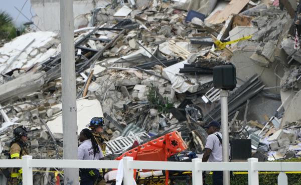 Emergency personnel work at the scene of a collapse of a 12-story condo building in the Surfside area of Miami. Emergency personnel work at the scene of a collapse of a 12-story condo building in the Surfside area of Miami.