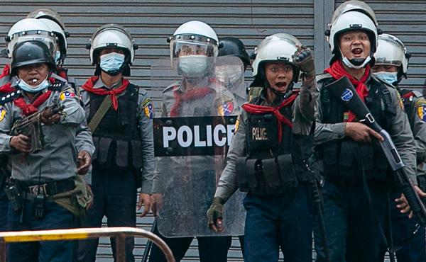 Police gesture toward protesters as security forces crack down on demonstrations against the military coup in Yangon on Sunday. The United Nations says at least 18 protesters were killed Sunday, the deadliest day yet since the military took power earlier Police gesture toward protesters as security forces crack down on demonstrations against the military coup in Yangon on Sunday. The United Nations says at least 18 protesters were killed Sunday, the deadliest day yet since the military took power earlier