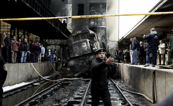 Policemen stand guard in front of a damaged train inside Ramses train station in Cairo, Egypt, on Wednesday. Policemen stand guard in front of a damaged train inside Ramses train station in Cairo, Egypt, on Wednesday.