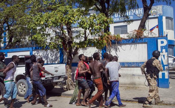 Police escort recaptured inmates back to the Croix-des-Bouquets Civil Prison after Thursday's outbreak in Port-au-Prince, Haiti. As of Friday night, authorities were still searching for more than 200 escapees. Police escort recaptured inmates back to the Croix-des-Bouquets Civil Prison after Thursday's outbreak in Port-au-Prince, Haiti. As of Friday night, authorities were still searching for more than 200 escapees.