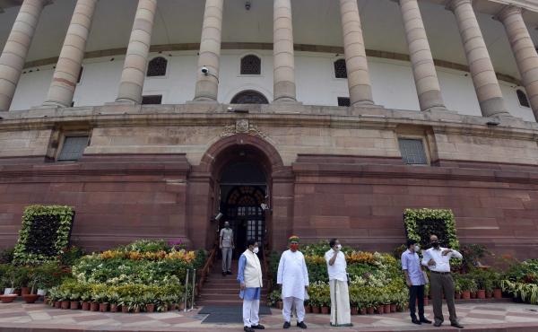 Politicians gathered at India's Parliament House ahead of the first session in six months, on Sept. 13 in New Delhi. Lawmakers were required to get tested for the coronavirus within 72 hours before entering parliament. Politicians gathered at India's Parliament House ahead of the first session in six months, on Sept. 13 in New Delhi. Lawmakers were required to get tested for the coronavirus within 72 hours before entering parliament.