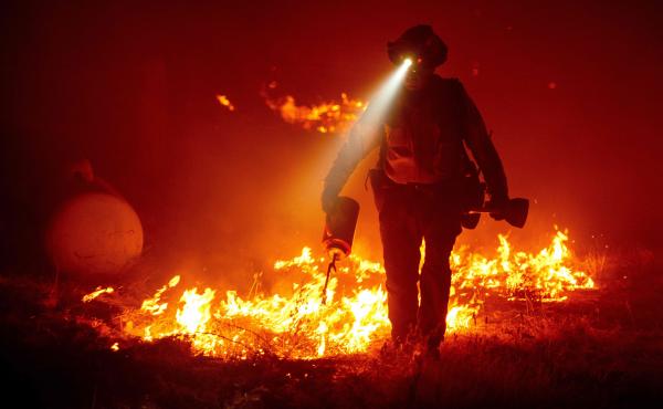 Firefighters cut defensive lines and light backfires to protect structures behind a Cal Fire fire station at the Bear Fire, part of the North Lightning Complex of fires in the Berry Creek area of Butte County, Calif., on Wednesday. Firefighters cut defensive lines and light backfires to protect structures behind a Cal Fire fire station at the Bear Fire, part of the North Lightning Complex of fires in the Berry Creek area of Butte County, Calif., on Wednesday.