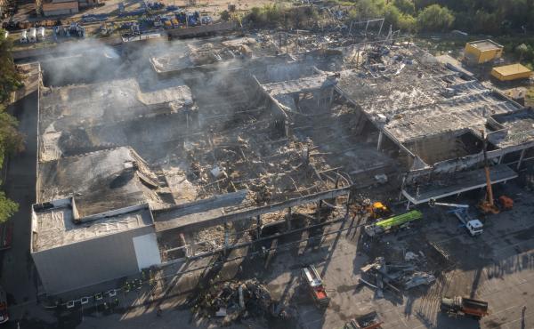 Ukrainian State Emergency Service firefighters work to take away debris at a shopping center burned after a rocket attack in Kremenchuk, Ukraine, Tuesday. Ukrainian State Emergency Service firefighters work to take away debris at a shopping center burned after a rocket attack in Kremenchuk, Ukraine, Tuesday.
