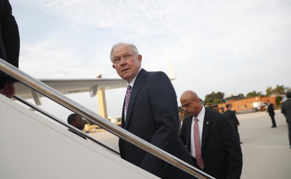 Attorney General Jeff Sessions boards a plane at Andrews Air Force Base, Md., Thursday, for El Salvador. His former Senate colleagues are rallying behind him amid withering attacks from President Trump. Attorney General Jeff Sessions boards a plane at Andrews Air Force Base, Md., Thursday, for El Salvador. His former Senate colleagues are rallying behind him amid withering attacks from President Trump.