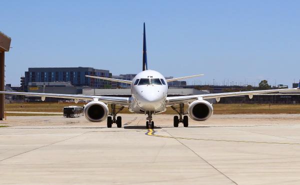 A plane sits at Melbourne Airport in December, ahead of the Australian Open. The country will reopen its international borders to visa holders and fully vaccinated travelers on Feb. 21. A plane sits at Melbourne Airport in December, ahead of the Australian Open. The country will reopen its international borders to visa holders and fully vaccinated travelers on Feb. 21.