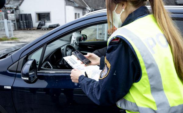 An Austrian police officer checks a driver's vaccination certificate during a traffic control stop in Graz, Austria, on Monday. An Austrian police officer checks a driver's vaccination certificate during a traffic control stop in Graz, Austria, on Monday.