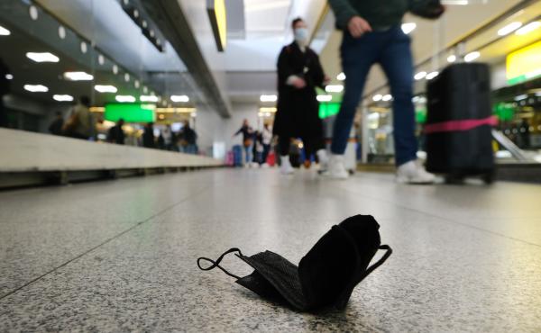 A discarded mask is seen on the floor inside New York's John F. Kennedy Airport on Tuesday, a day after a federal judge in Florida struck down the CDC's mask mandate for public transportation. A discarded mask is seen on the floor inside New York's John F. Kennedy Airport on Tuesday, a day after a federal judge in Florida struck down the CDC's mask mandate for public transportation.