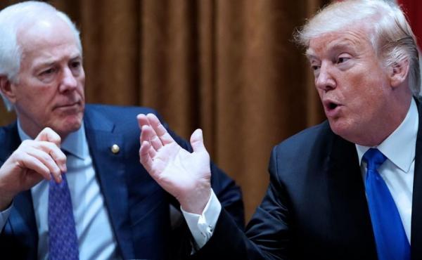 President Trump speaks, watched by Sen. John Cornyn, R-Texas, during a bipartisan meeting with members of Congress on school and community safety at the White House on Wednesday. President Trump speaks, watched by Sen. John Cornyn, R-Texas, during a bipartisan meeting with members of Congress on school and community safety at the White House on Wednesday.
