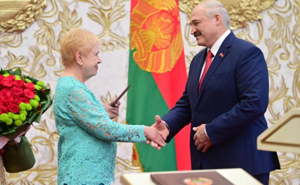 Lidia Yermoshina (left) chairperson of the Belarusian Central Election Commission, hands over a presidential ID to President Alexander Lukashenko during an inauguration ceremony Wednesday at Independence Palace in Minsk. Lidia Yermoshina (left) chairperson of the Belarusian Central Election Commission, hands over a presidential ID to President Alexander Lukashenko during an inauguration ceremony Wednesday at Independence Palace in Minsk.
