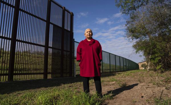 Juliet García, former president of the University of Texas at Brownsville, stands behind the border wall. Juliet García, former president of the University of Texas at Brownsville, stands behind the border wall.