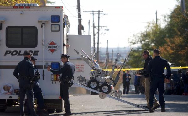 Law enforcement personnel operate a bomb disposal robot outside a post office which had been evacuated in Wilmington, Del., on Thursday. Law enforcement personnel operate a bomb disposal robot outside a post office which had been evacuated in Wilmington, Del., on Thursday.