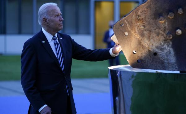 President Biden touches a piece of steel from the World Trade Center at a memorial to the 9/11 attacks Monday at NATO headquarters in Brussels. NATO allies joined in a collective defense with the U.S. after the terror attacks. President Biden touches a piece of steel from the World Trade Center at a memorial to the 9/11 attacks Monday at NATO headquarters in Brussels. NATO allies joined in a collective defense with the U.S. after the terror attacks.