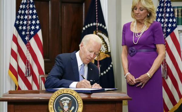 President Biden signs into law the Bipartisan Safer Communities Act gun safety bill, in the Roosevelt Room of the White House on Saturday as first lady Jill Biden looks on. President Biden signs into law the Bipartisan Safer Communities Act gun safety bill, in the Roosevelt Room of the White House on Saturday as first lady Jill Biden looks on.