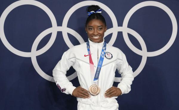 Simone Biles poses wearing her bronze medal from balance beam competition during artistic gymnastics at the Summer Olympics on Aug. 3, 2021, in Tokyo. President Biden will present the Presidential Medal of Freedom to Biles and 16 others at the White House Simone Biles poses wearing her bronze medal from balance beam competition during artistic gymnastics at the Summer Olympics on Aug. 3, 2021, in Tokyo. President Biden will present the Presidential Medal of Freedom to Biles and 16 others at the White House