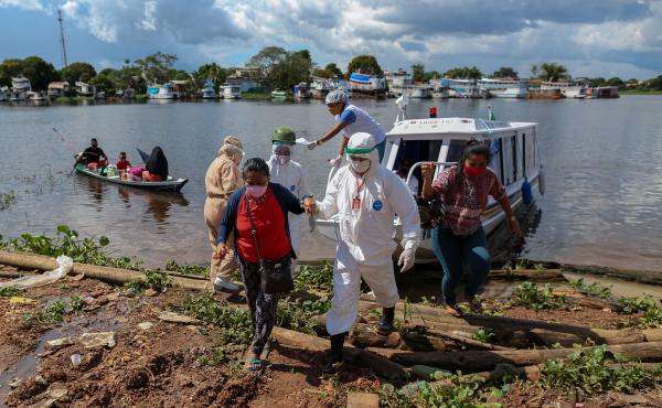 A surge in cases and record high daily death tolls have pushed Brazil into a COVID crisis. Above: Health professionals help patients with symptoms of the new coronavirus on a boat ambulance. A surge in cases and record high daily death tolls have pushed Brazil into a COVID crisis. Above: Health professionals help patients with symptoms of the new coronavirus on a boat ambulance.