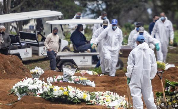 Several COVID-19 burials are performed in the Vila Formosa Cemetery on the east side of São Paulo, Brazil, on Sunday. Brazil, which reported a large spike in cases on Monday, now ranks second after the U.S. for total infections and deaths. Several COVID-19 burials are performed in the Vila Formosa Cemetery on the east side of São Paulo, Brazil, on Sunday. Brazil, which reported a large spike in cases on Monday, now ranks second after the U.S. for total infections and deaths.