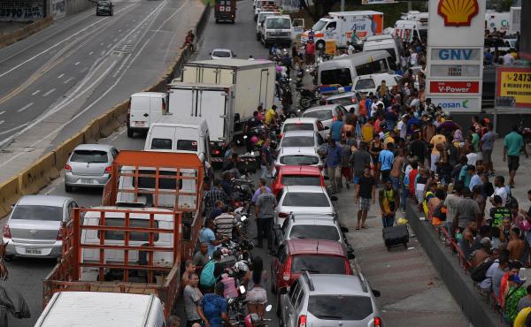Long, crowded lines extend from a gas station Monday in Rio de Janeiro. For more than a week, a massive truckers' strike has paralyzed fuel and food deliveries across Brazil. Long, crowded lines extend from a gas station Monday in Rio de Janeiro. For more than a week, a massive truckers' strike has paralyzed fuel and food deliveries across Brazil.
