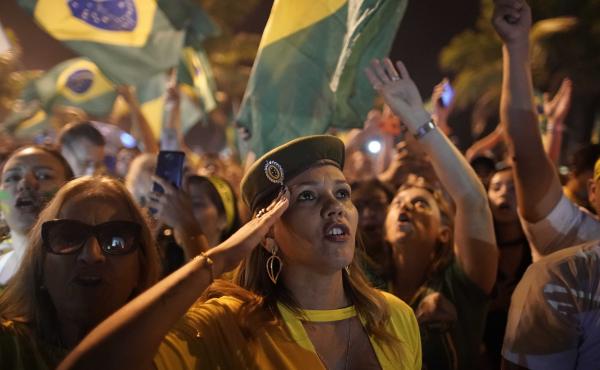 A supporter of Jair Bolsonaro salutes during a celebration in front of his residence after he was declared the winner of the election runoff, in Rio de Janeiro, on Sunday. A supporter of Jair Bolsonaro salutes during a celebration in front of his residence after he was declared the winner of the election runoff, in Rio de Janeiro, on Sunday.