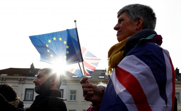 An anti-Brexit demonstrator holds British and European Union flags during a protest in front of the European Parliament in Brussels on Thursday. An anti-Brexit demonstrator holds British and European Union flags during a protest in front of the European Parliament in Brussels on Thursday.
