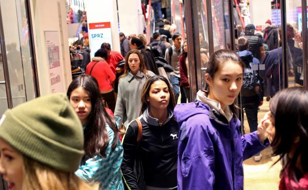 Shoppers walk out of Uniqlo on 5th Ave. in New York City on Black Friday, Nov. 27. Shoppers walk out of Uniqlo on 5th Ave. in New York City on Black Friday, Nov. 27.