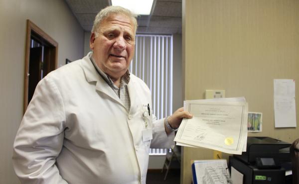 Dr. David Burkons holds the licensing certificates that allowed him to open a clinic that provides medical and surgical abortions. It took about 18 extra months of inspections, he says, to get the approval to offer surgical abortions. Dr. David Burkons holds the licensing certificates that allowed him to open a clinic that provides medical and surgical abortions. It took about 18 extra months of inspections, he says, to get the approval to offer surgical abortions.