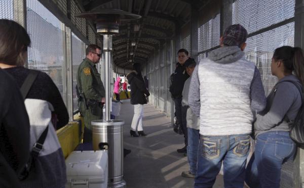 A Border Patrol agent and a U.S. Customs and Border Protection agent oversee the people waiting to cross into the U.S. from Matamoros, Mexico, at the Port of Entry in Brownsville, Tex., Tuesday, last month. A Border Patrol agent and a U.S. Customs and Border Protection agent oversee the people waiting to cross into the U.S. from Matamoros, Mexico, at the Port of Entry in Brownsville, Tex., Tuesday, last month.