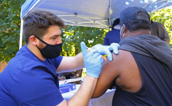 A health care worker administers a Pfizer-BioNTech COVID-19 vaccine Thursday at Life of Hope Center in New York City. A health care worker administers a Pfizer-BioNTech COVID-19 vaccine Thursday at Life of Hope Center in New York City.