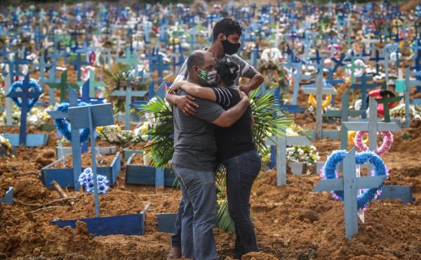 Relatives at a mass burial of pandemic victims at the Parque Taruma cemetery in Manaus, Brazil, mourn a family member. Relatives at a mass burial of pandemic victims at the Parque Taruma cemetery in Manaus, Brazil, mourn a family member.