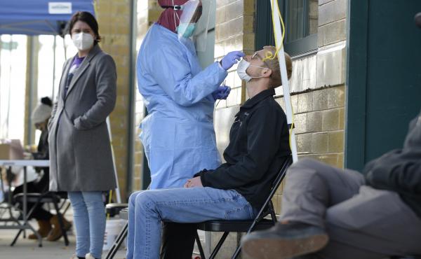 A medical staff member performs a COVID-19 test outside the Family Healthcare building in downtown Fargo, North Dakota, on Oct. 15. North Dakota is experiencing an influx in COVID-19 cases and on Nov. 6, the state reported a record high of 1,765 daily new A medical staff member performs a COVID-19 test outside the Family Healthcare building in downtown Fargo, North Dakota, on Oct. 15. North Dakota is experiencing an influx in COVID-19 cases and on Nov. 6, the state reported a record high of 1,765 daily new