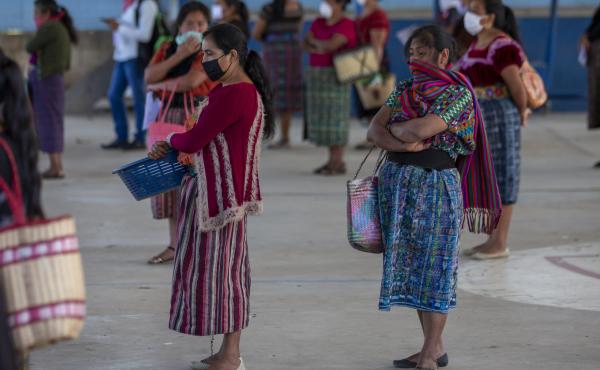 Women wearing face masks stand at a safe distance to help curb the spread of the new coronavirus, as they wait for food assigned to their children outside a school in Xesuj, Guatemala, where many residents depend on remittances, largely from the U.S. The Women wearing face masks stand at a safe distance to help curb the spread of the new coronavirus, as they wait for food assigned to their children outside a school in Xesuj, Guatemala, where many residents depend on remittances, largely from the U.S. The