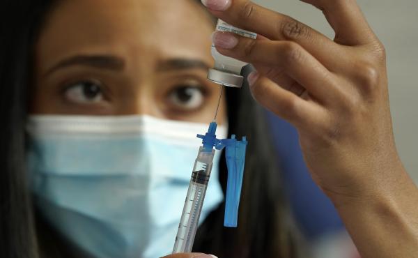 Licensed practical nurse Yokasta Castro, of Warwick, R.I., draws a Moderna COVID-19 vaccine into a syringe. The vaccines have now been linked to minor changes in menstruation, but are still considered safe. Licensed practical nurse Yokasta Castro, of Warwick, R.I., draws a Moderna COVID-19 vaccine into a syringe. The vaccines have now been linked to minor changes in menstruation, but are still considered safe.