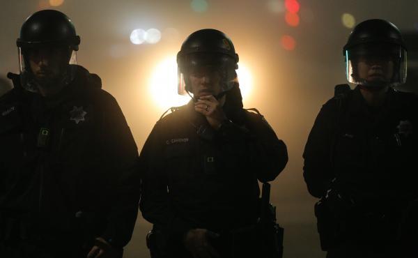 Oakland police officers, wearing body cameras, form a line during demonstrations against recent incidents of alleged police brutality nationwide. Oakland police officers, wearing body cameras, form a line during demonstrations against recent incidents of alleged police brutality nationwide.