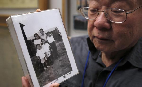 During a visit last week to the California Museum in Sacramento, Les Ouchida holds a 1943 photo of himself (front row center) and his siblings taken at the internment camp in Jerome, Ark., that his family was moved to from their home near Sacramento in 19 During a visit last week to the California Museum in Sacramento, Les Ouchida holds a 1943 photo of himself (front row center) and his siblings taken at the internment camp in Jerome, Ark., that his family was moved to from their home near Sacramento in 19