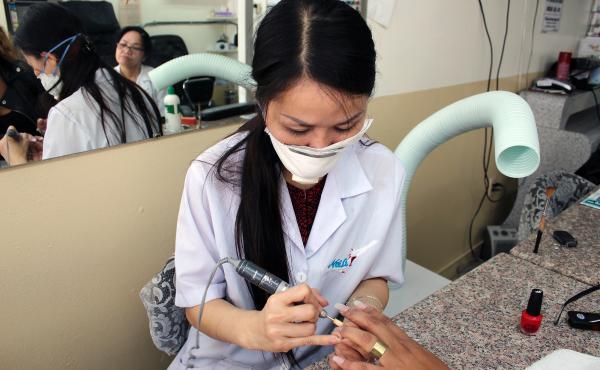 Mai Dang, who owns Fashion Nails in Berkeley, Calif., does a client's nails. The ventilator hose poised over her shoulder helps keeps noxious fumes at bay. Mai Dang, who owns Fashion Nails in Berkeley, Calif., does a client's nails. The ventilator hose poised over her shoulder helps keeps noxious fumes at bay.