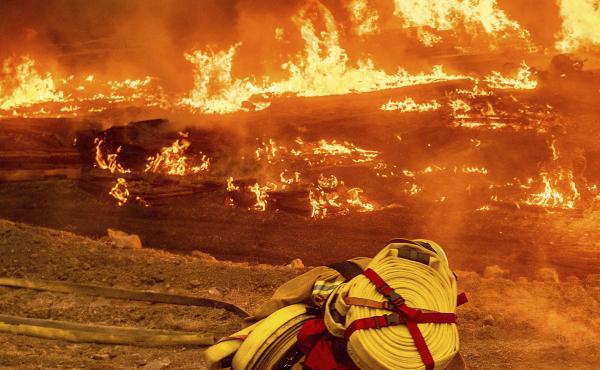 A firefighter battles the Glass Fire in Napa Valley, Calif., on Thursday. A firefighter battles the Glass Fire in Napa Valley, Calif., on Thursday.