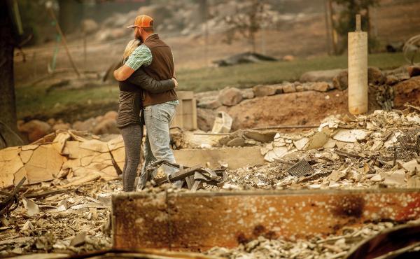 Chris and Nancy Brown embrace while searching through the remains of their home, leveled by the Camp Fire in Paradise, Calif. Chris and Nancy Brown embrace while searching through the remains of their home, leveled by the Camp Fire in Paradise, Calif.
